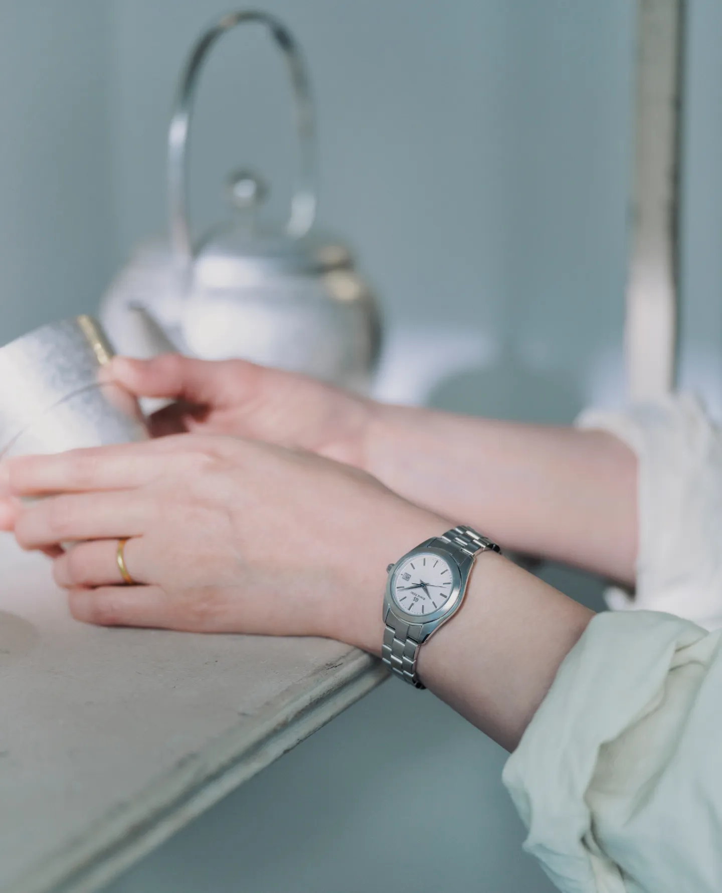 Metal artist Naho Kamada wearing a Grand Seiko watch.