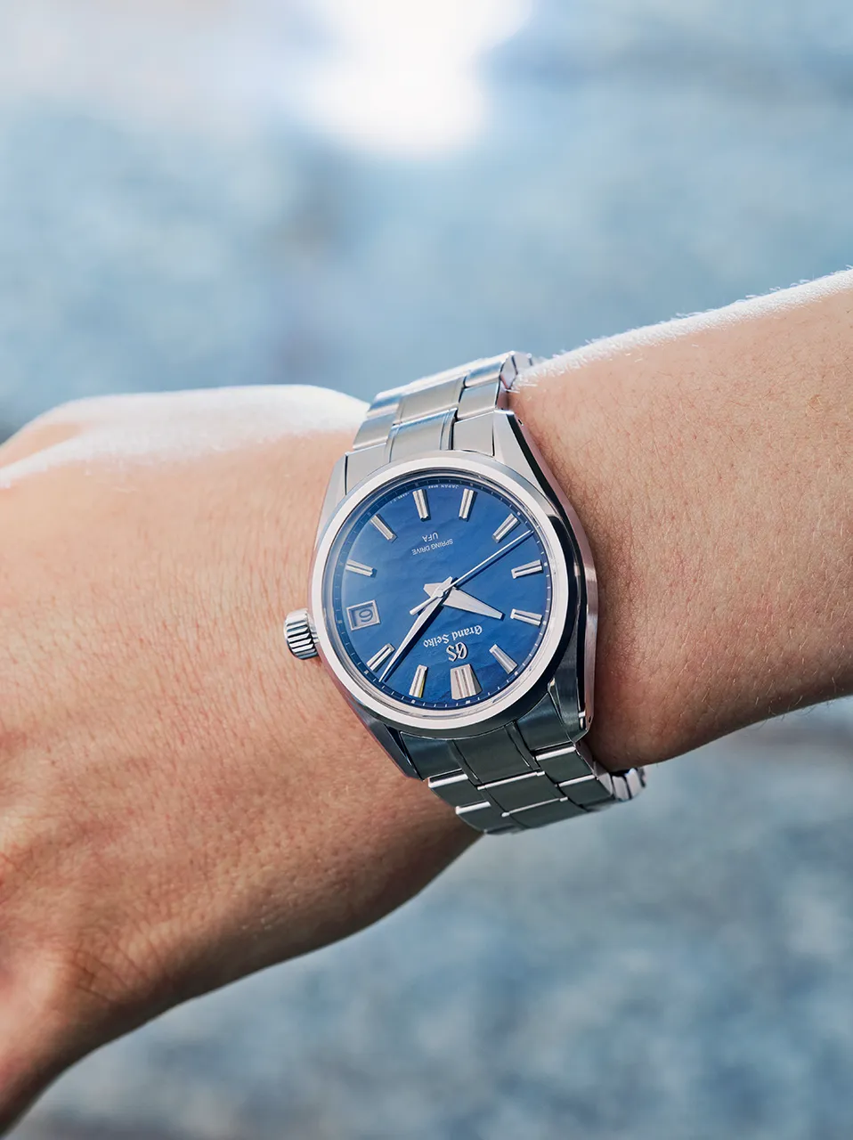 A visual capturing the wrist of a model wearing the GRAND SEIKO watch SLGB013, with the theme of LIGHT & SHADOW.